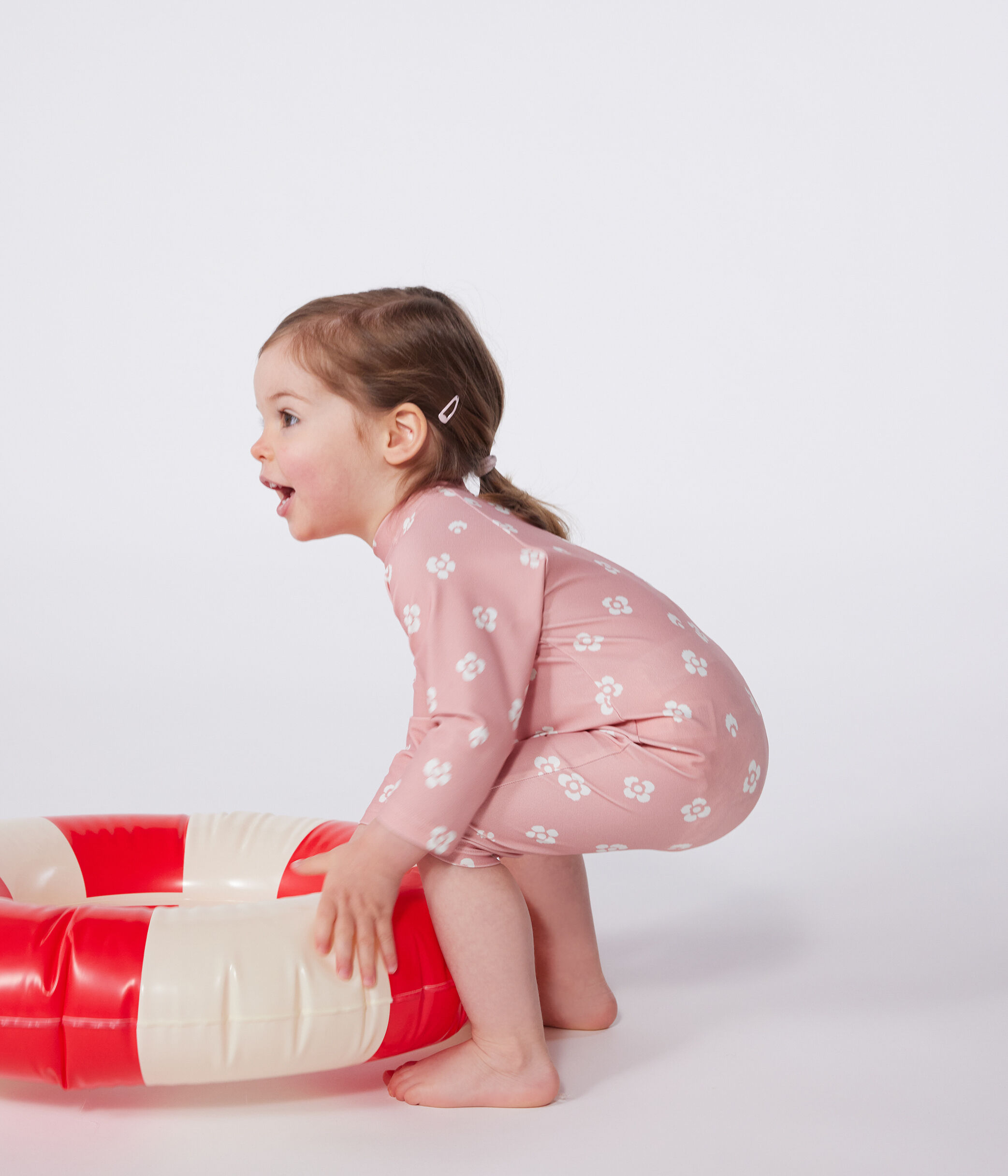 Tutina anti UV con stampa a fiori neonato rosa/bianco